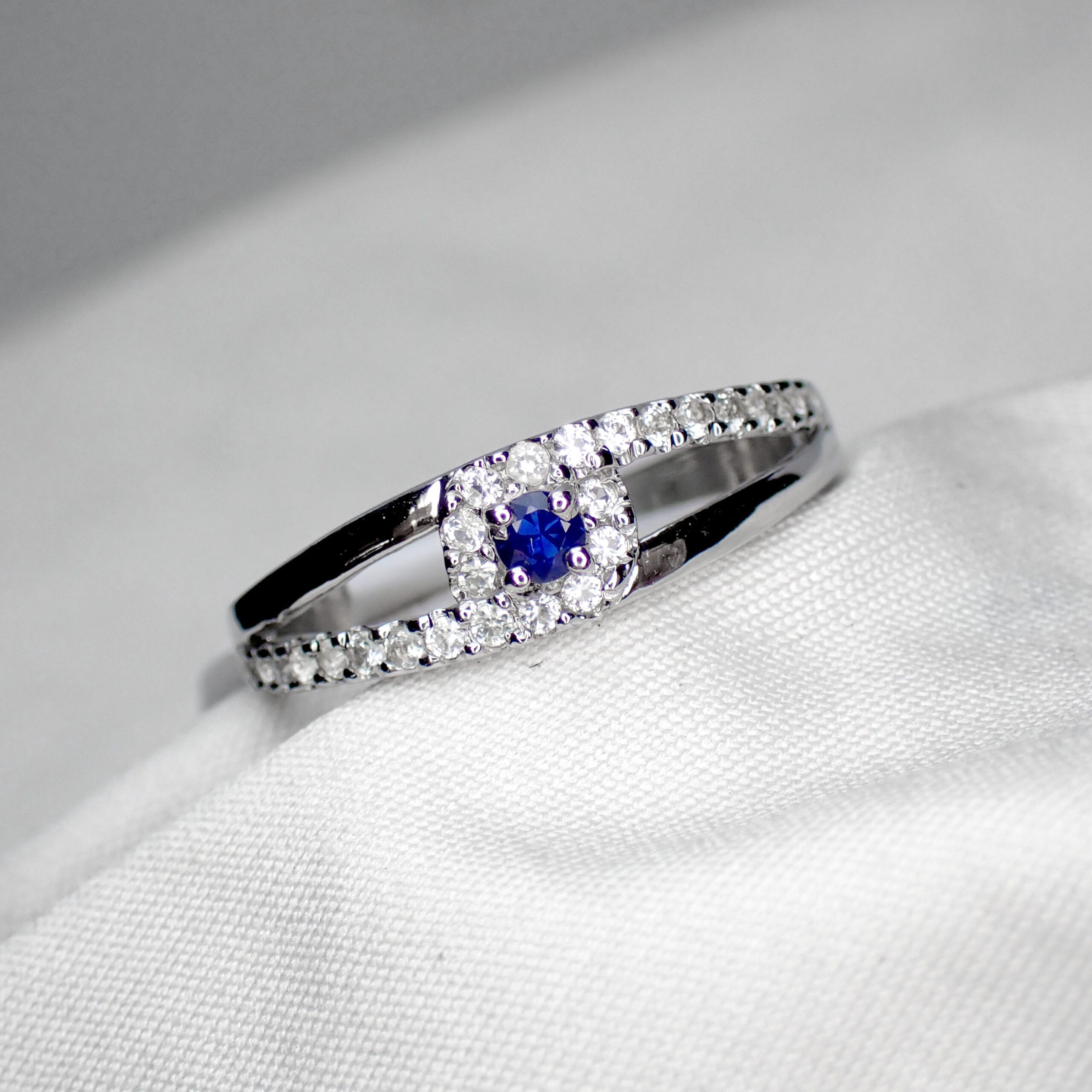 Blue Sapphire Ring with Asymmetric White Sapphire Accents - 1